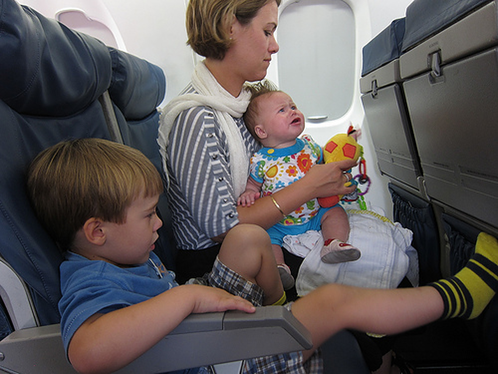 Mother with kids on a plane.