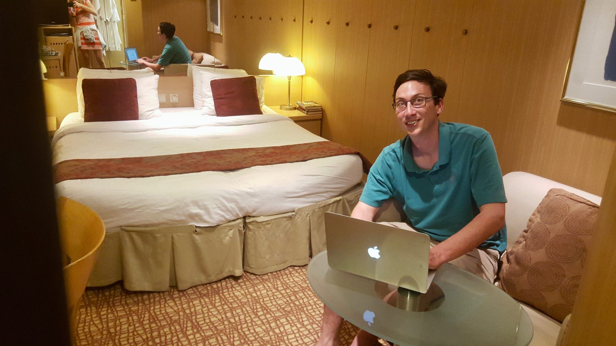 Man using macbook in hotel room.