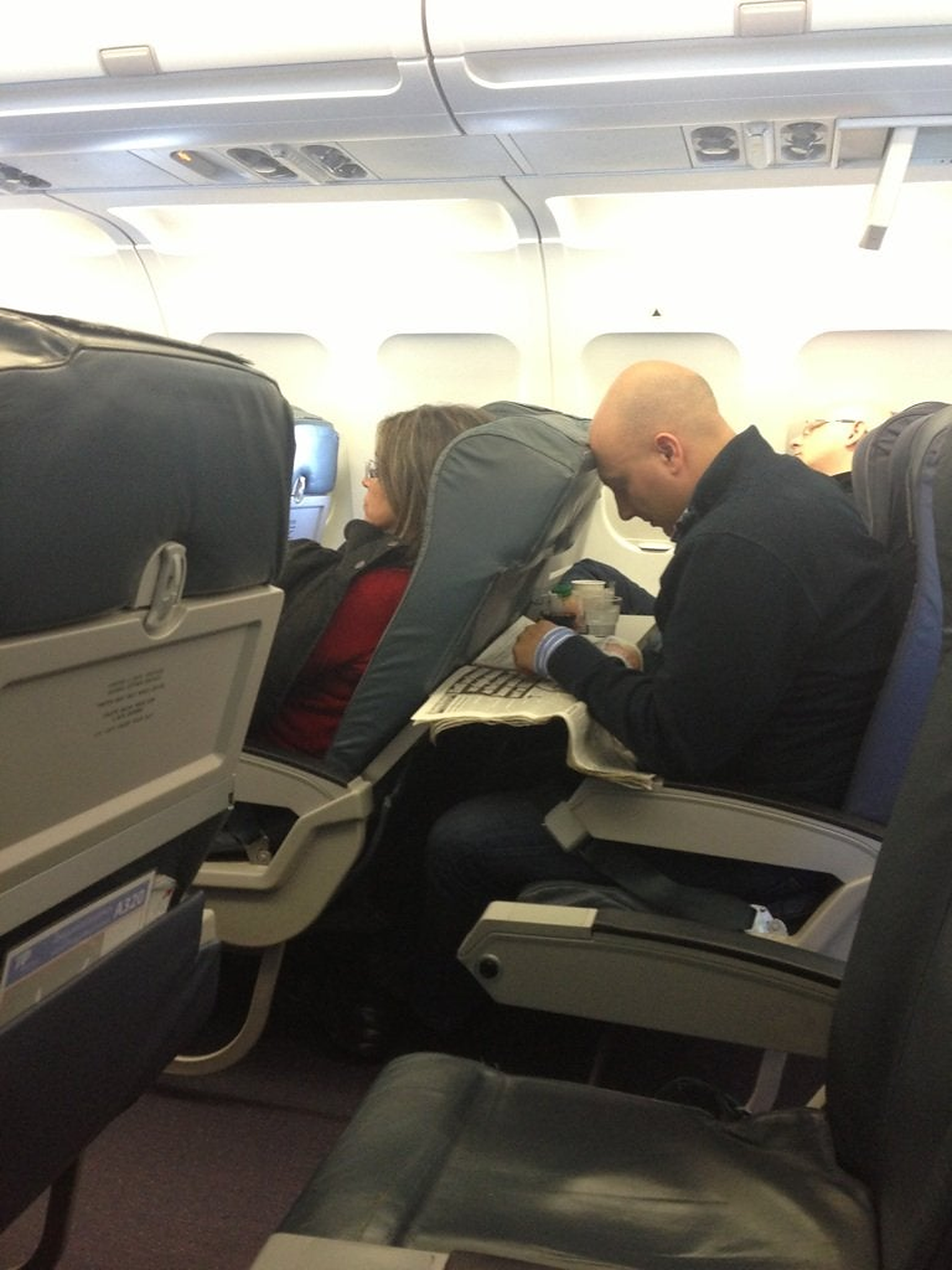 Woman reclining her seat on a plane.