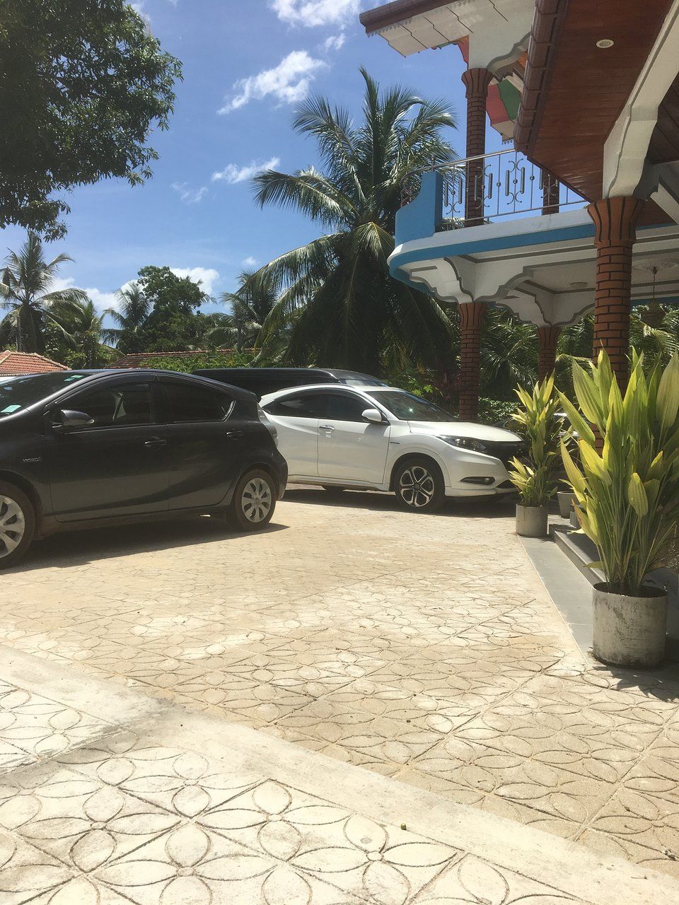 Parked cars in front of resort.