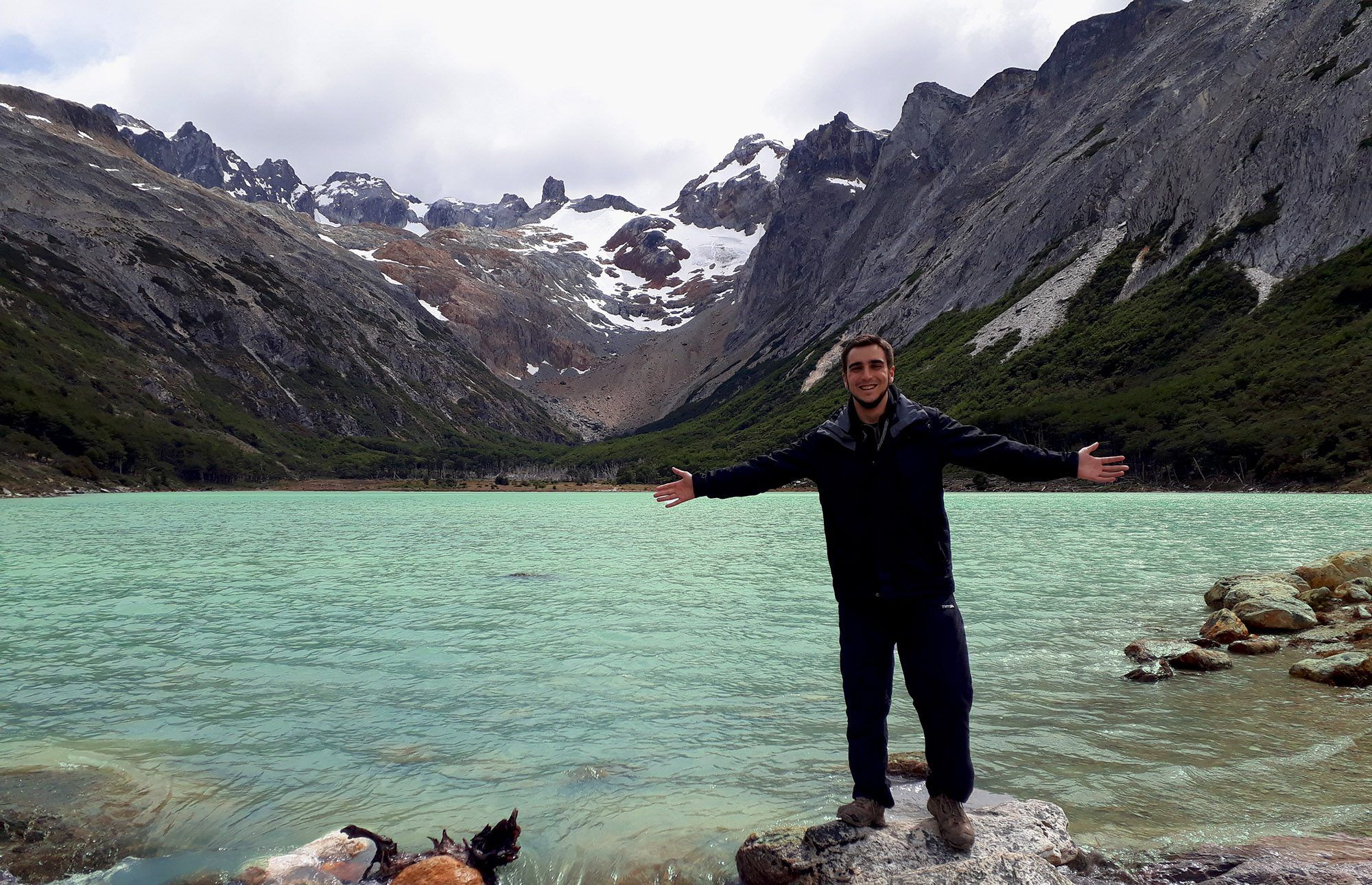 Man standing in front of Ushuaia lake
