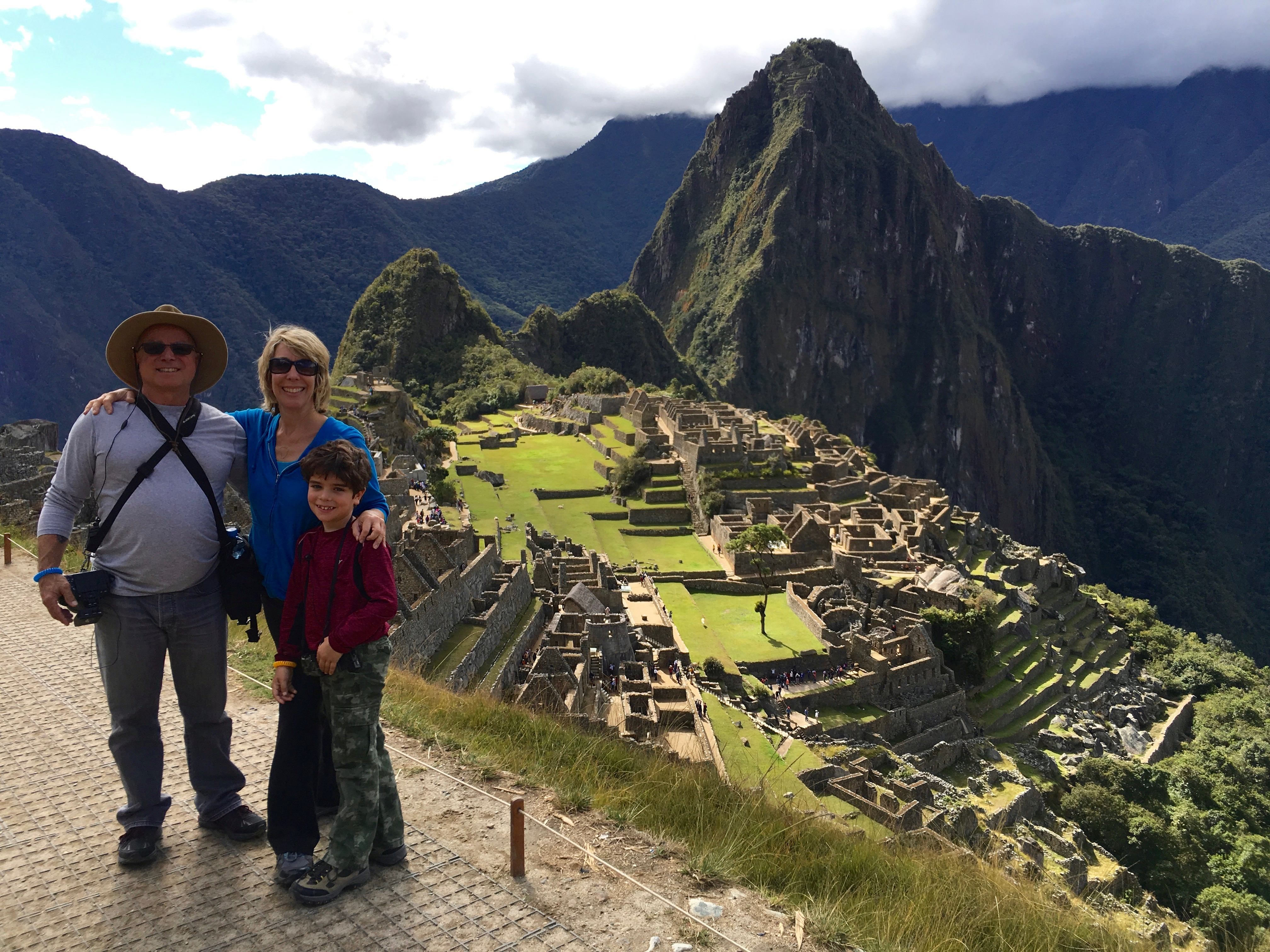 Family on hill overlooking Machu Picchu
