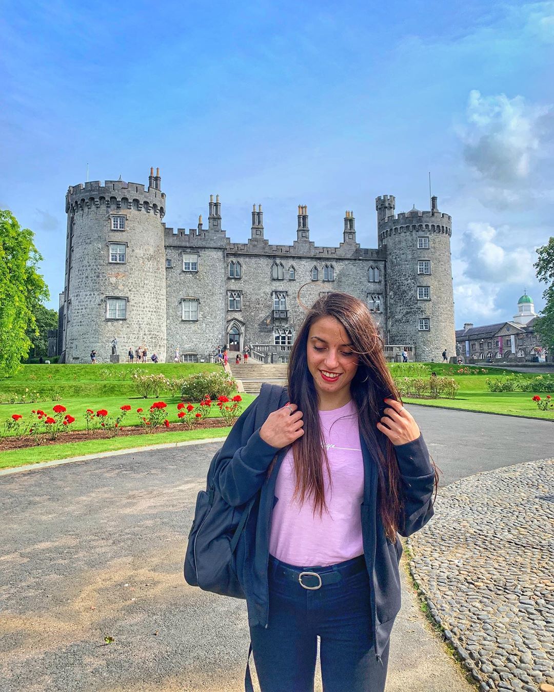 Someone standing near a castle in Ireland