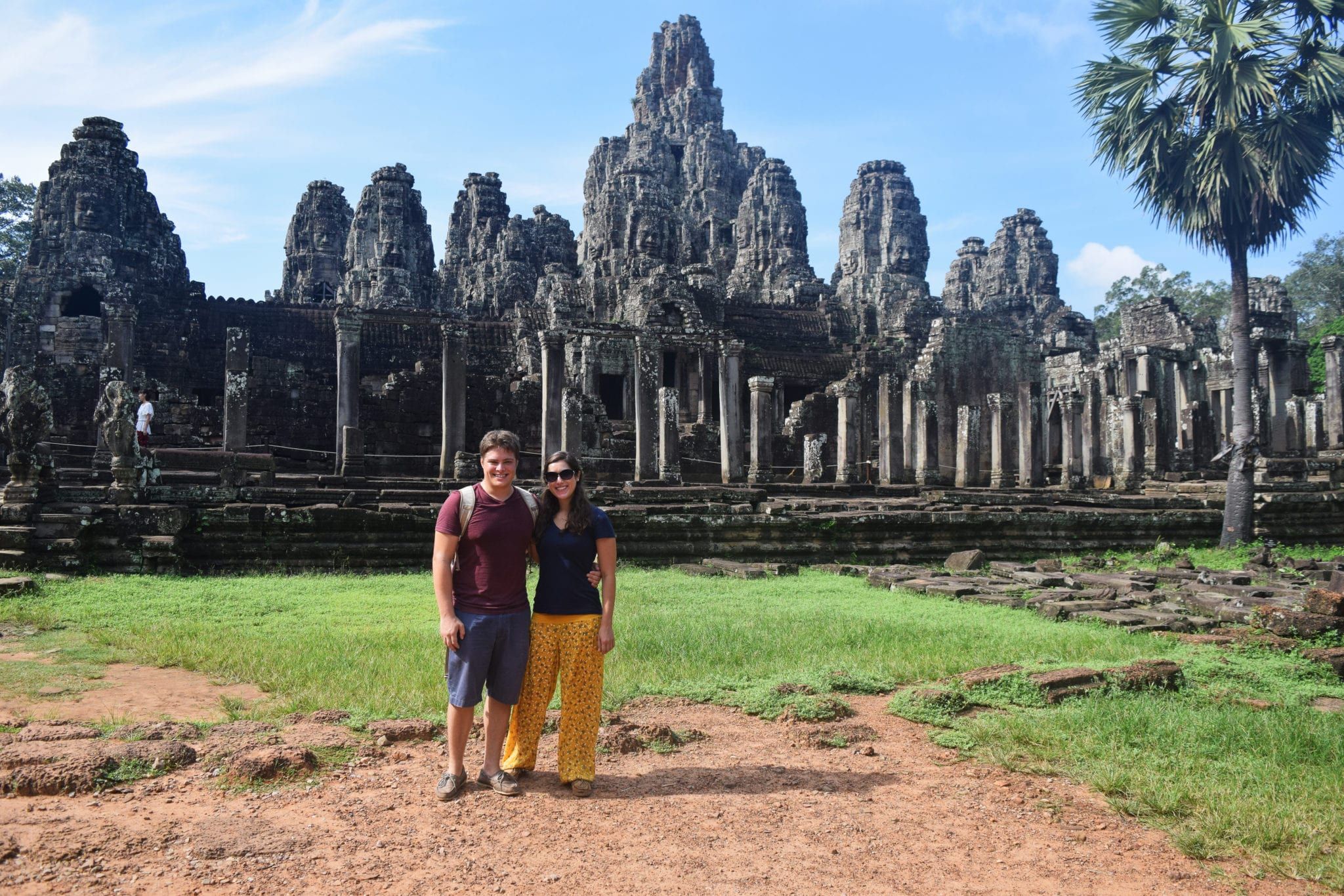 Two people standing outside of Angkor Wat