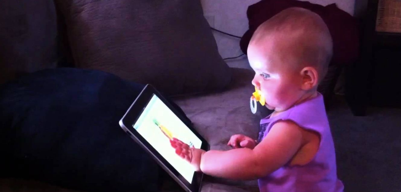 baby fascinated by an ipad