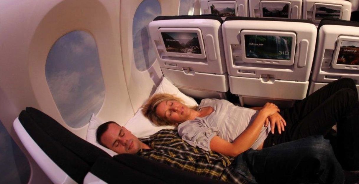 couple resting on airplane seats