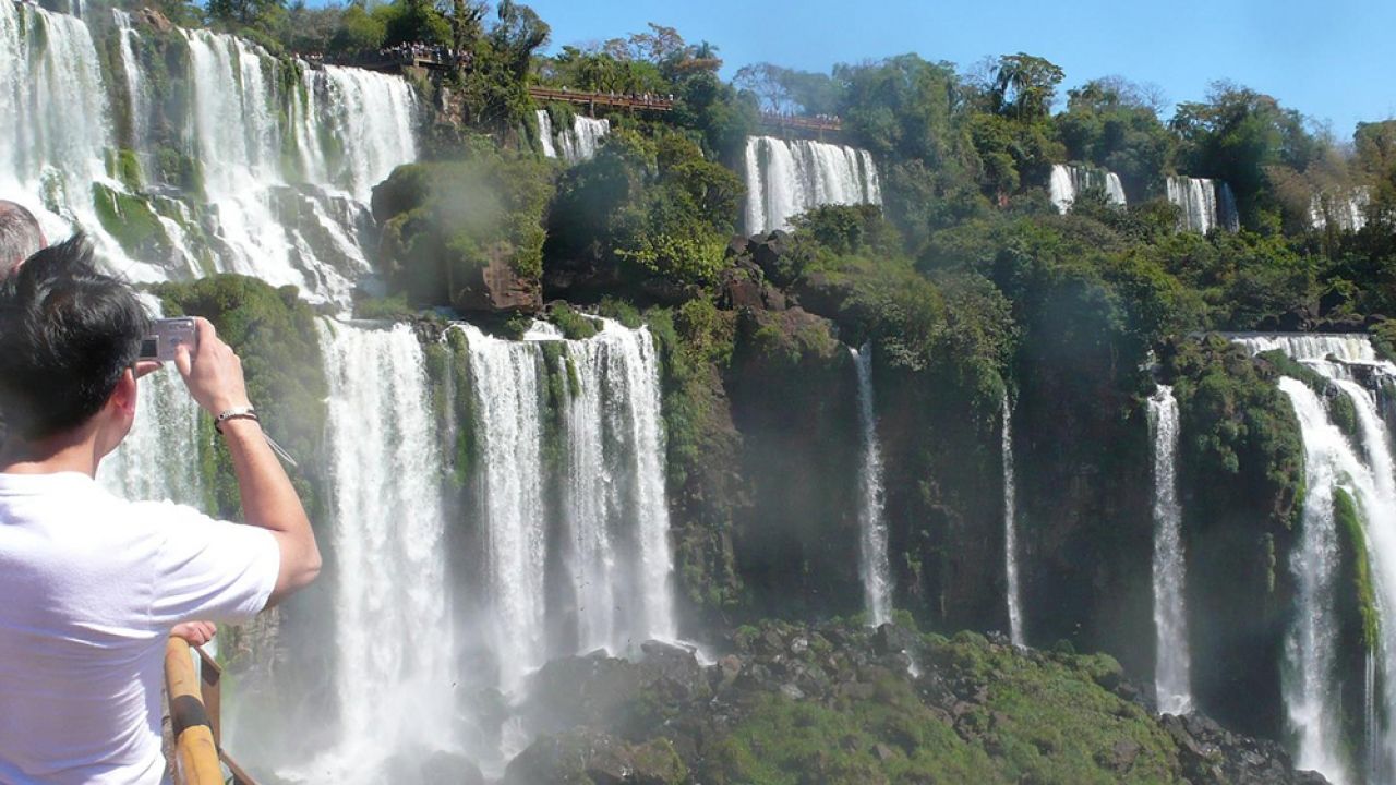 Woman taking photo of Iguazu