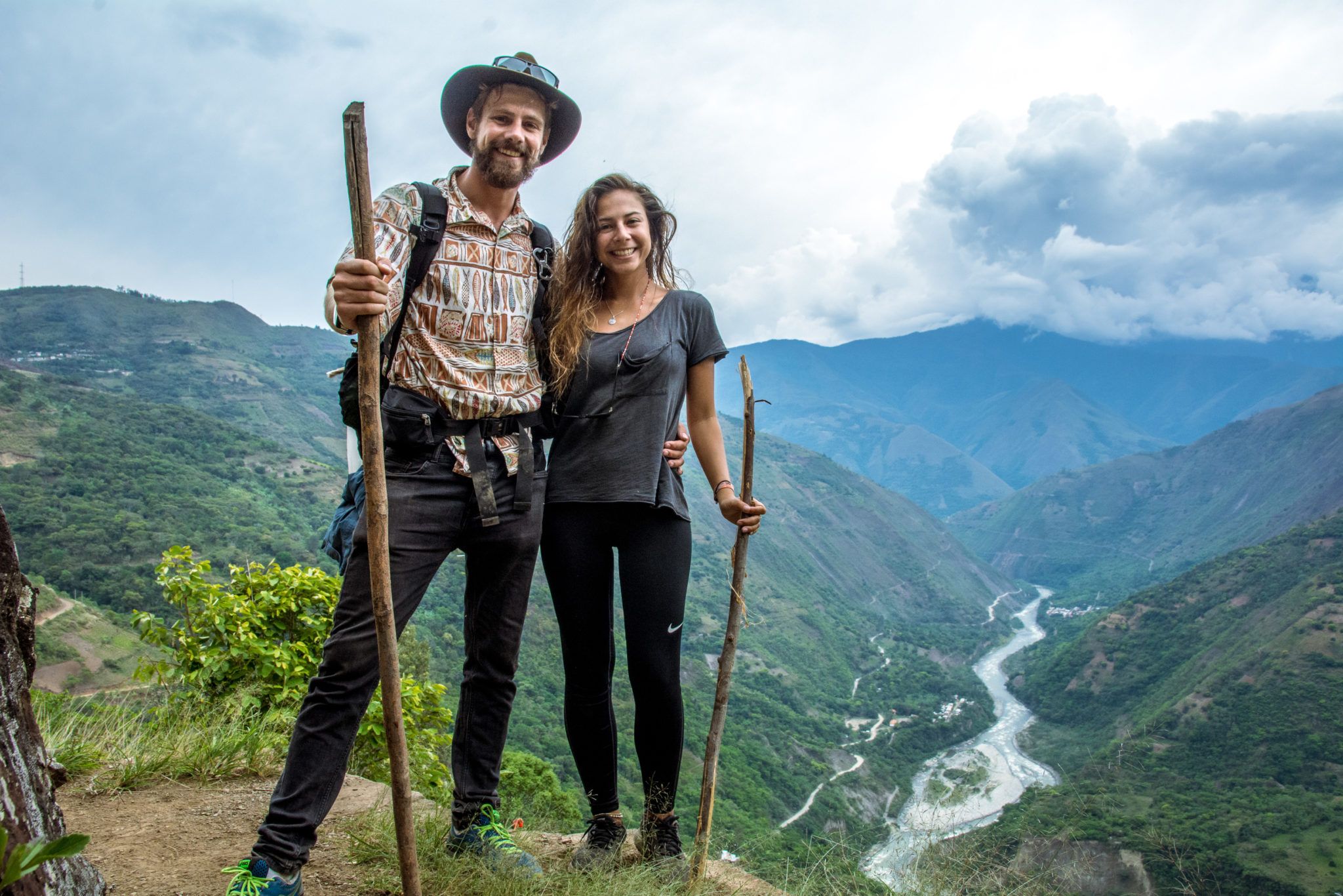 Hikers standing over river in Peru
