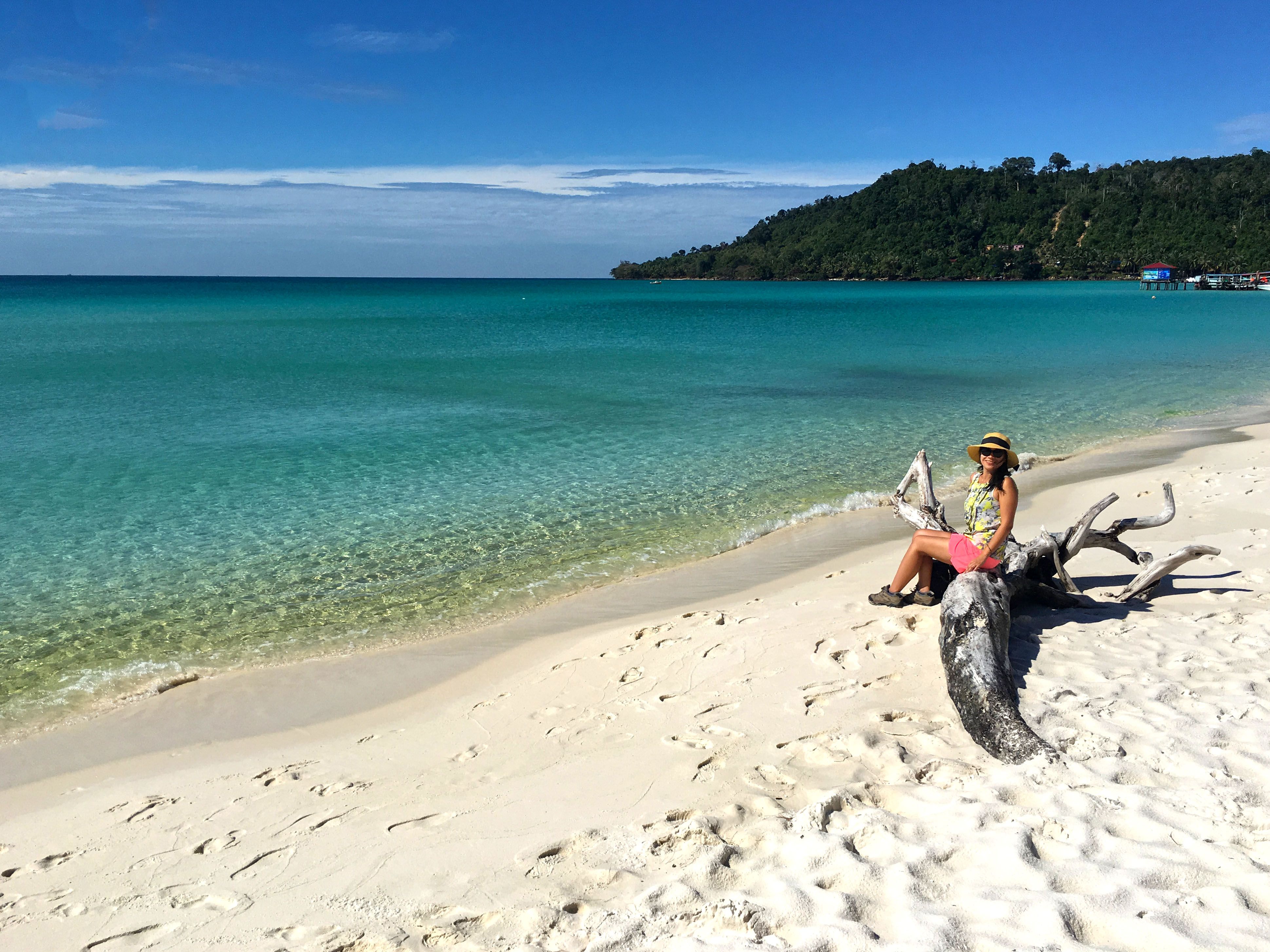 Woman sitting on tree branch at Koh Rong