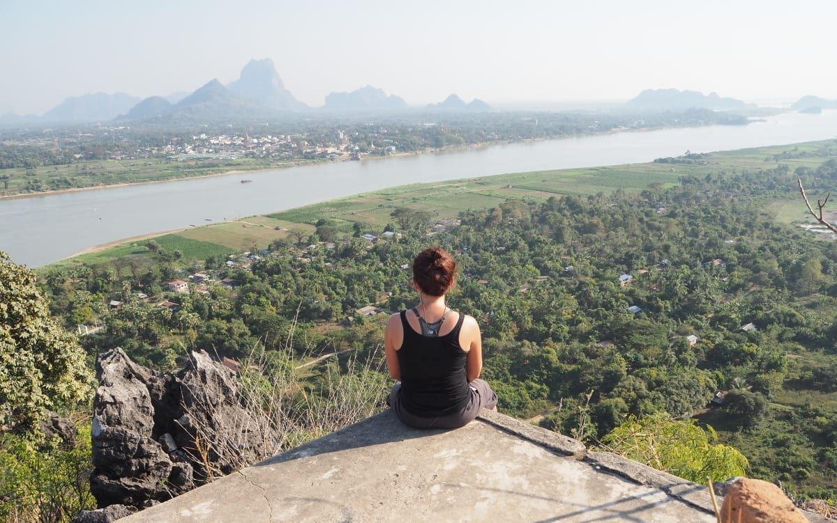 Person looking down at farms and river in Hpa-An from viewpoint