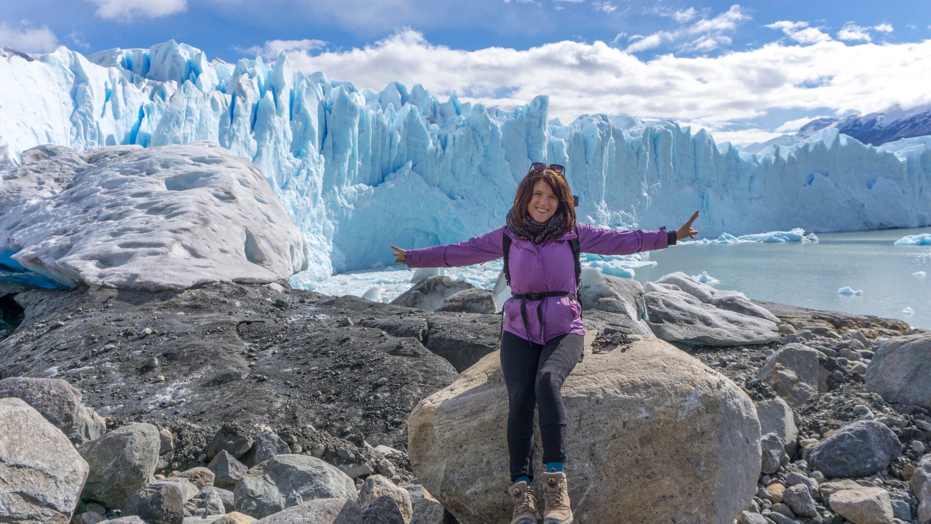 Woman standing in front of glacier 