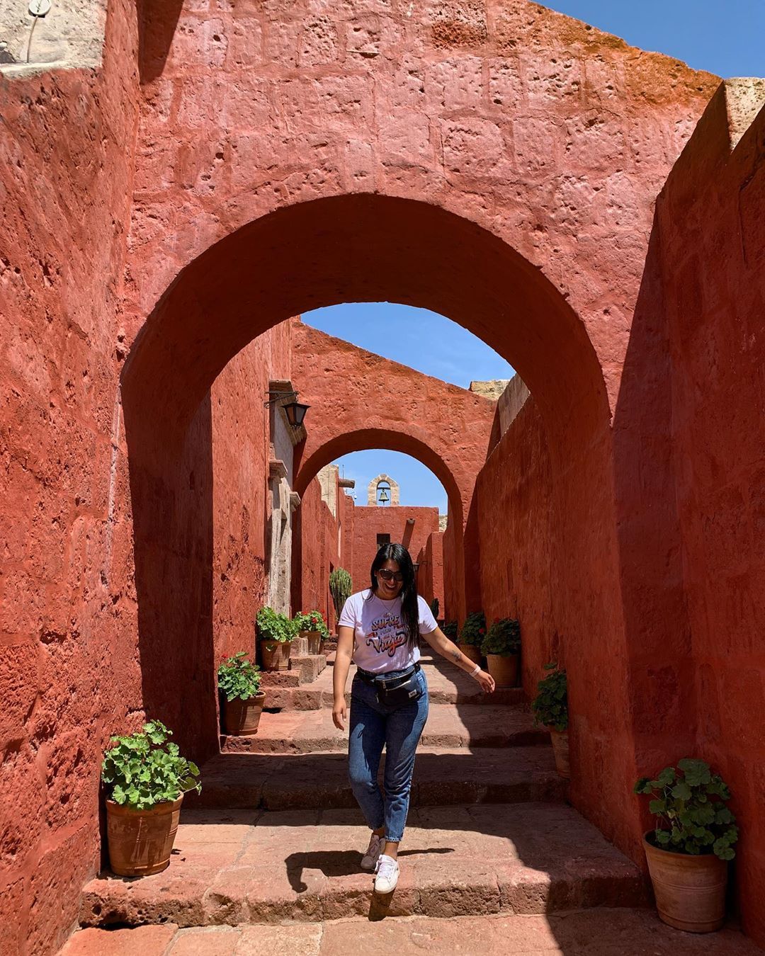 Woman in red arches at Catalina Monastery