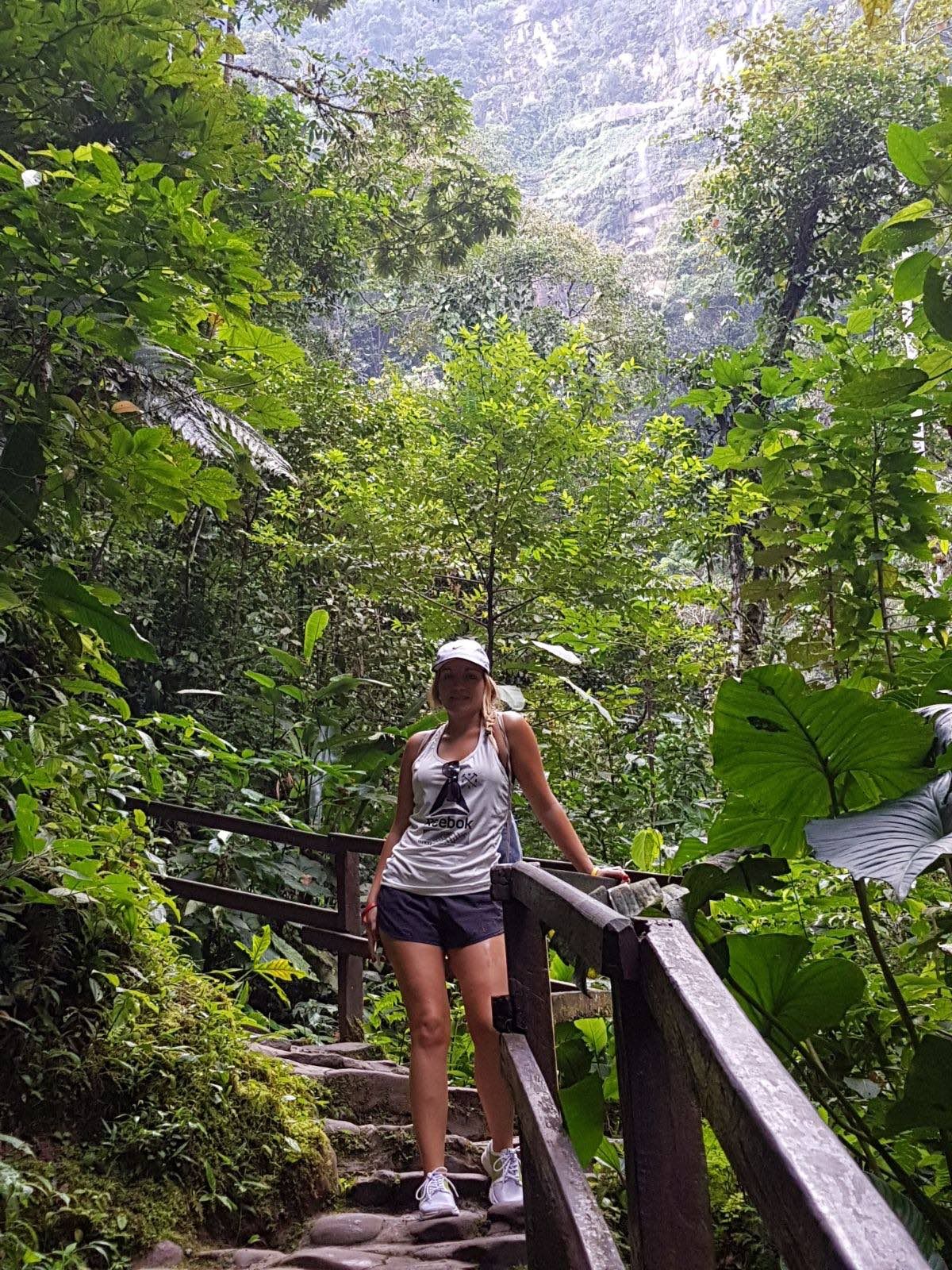 Woman walking wooden path in Amazon rainforest