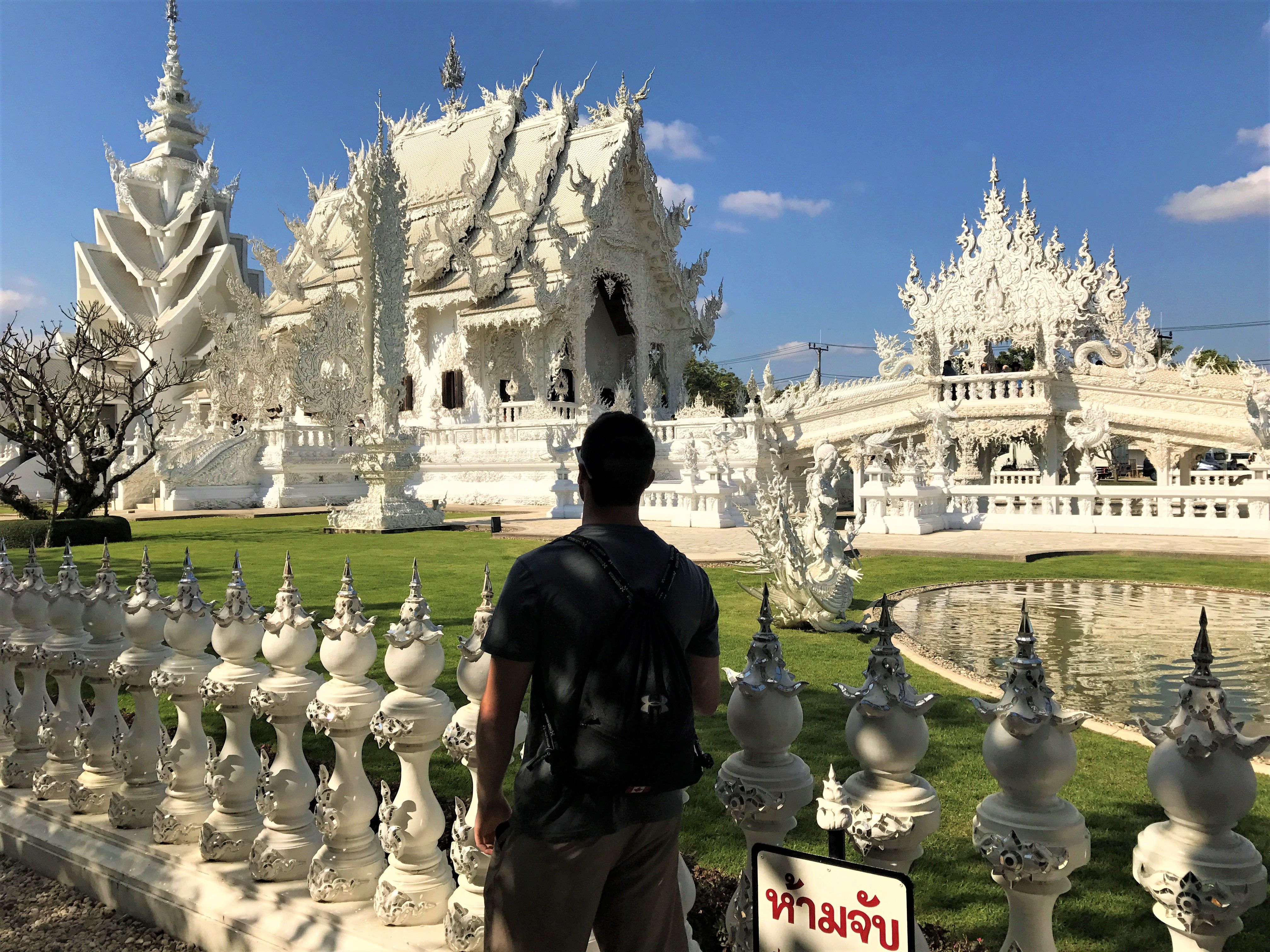 Man looking at White Temple in Thailand