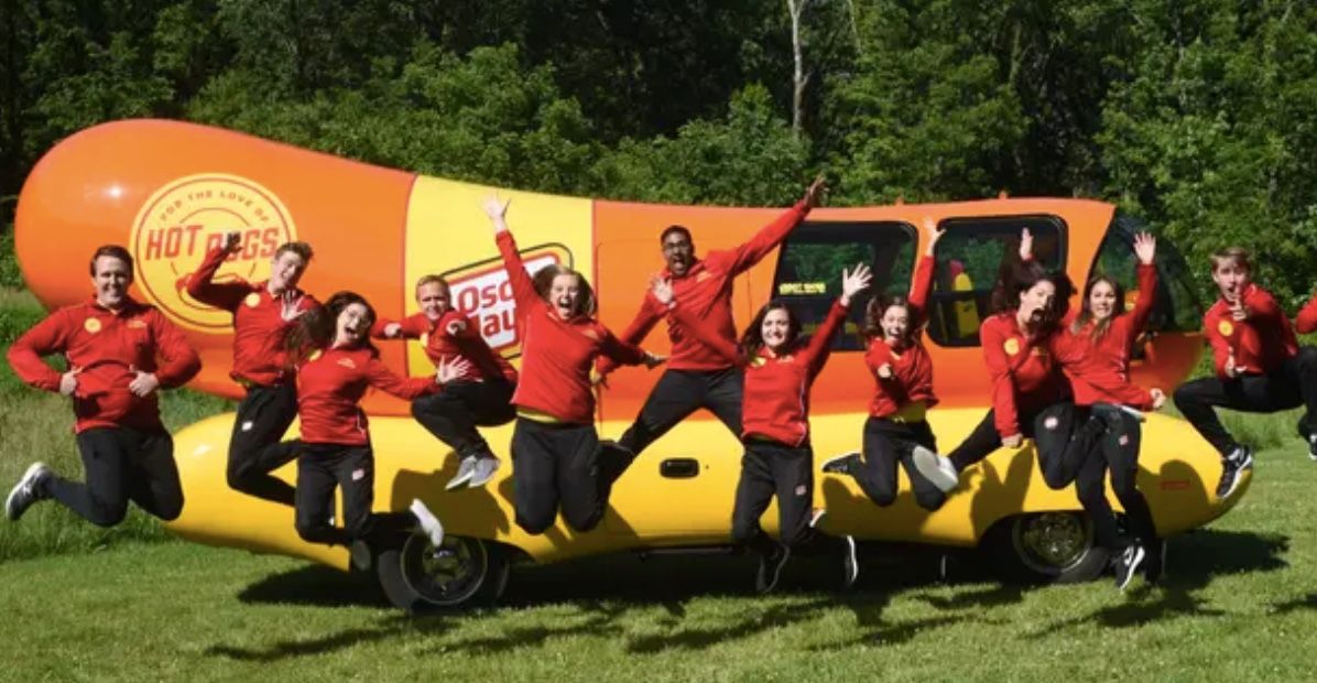 gang celebrating with the wienermobile