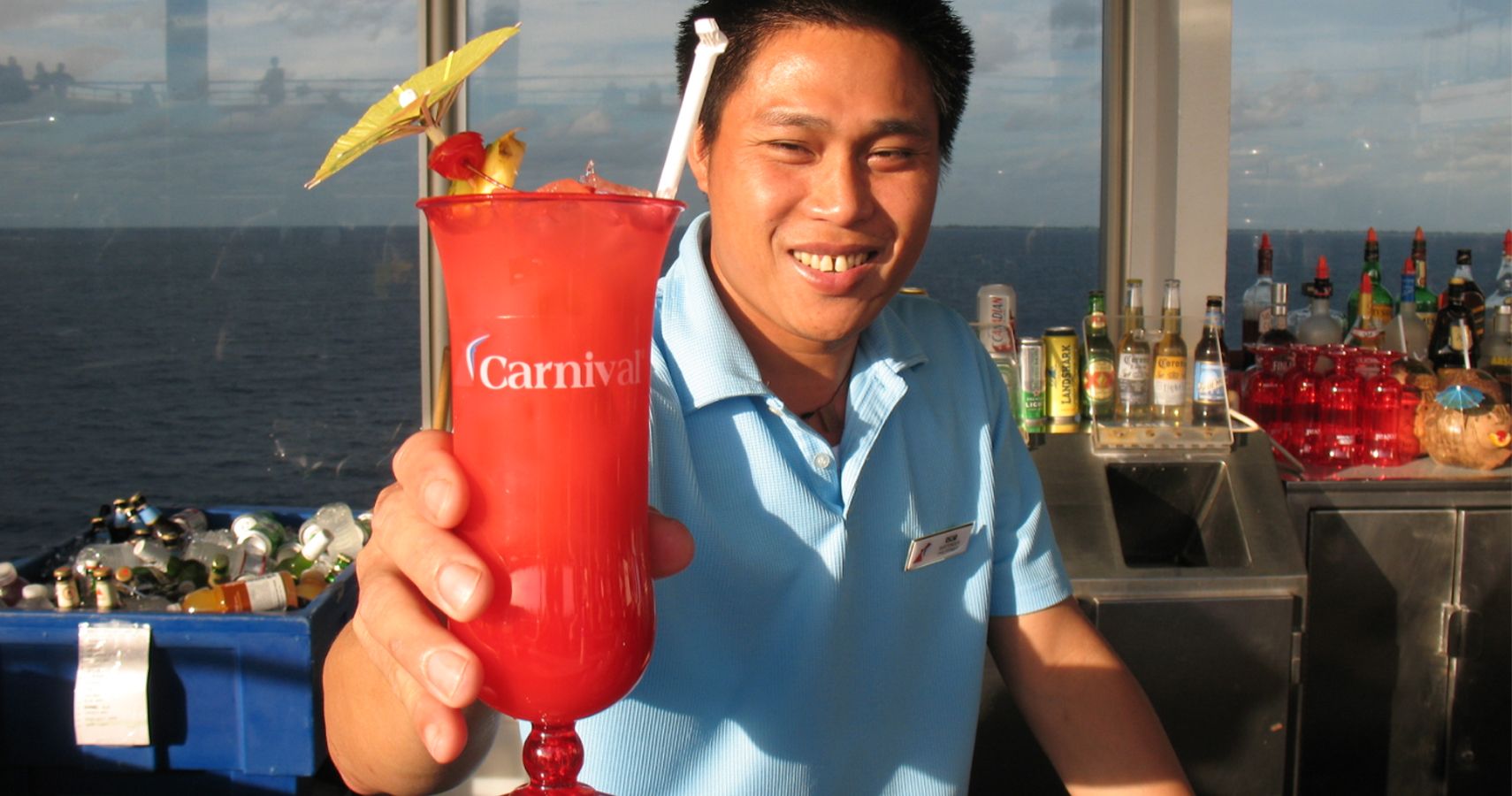Carnival cruise bartender serving drink