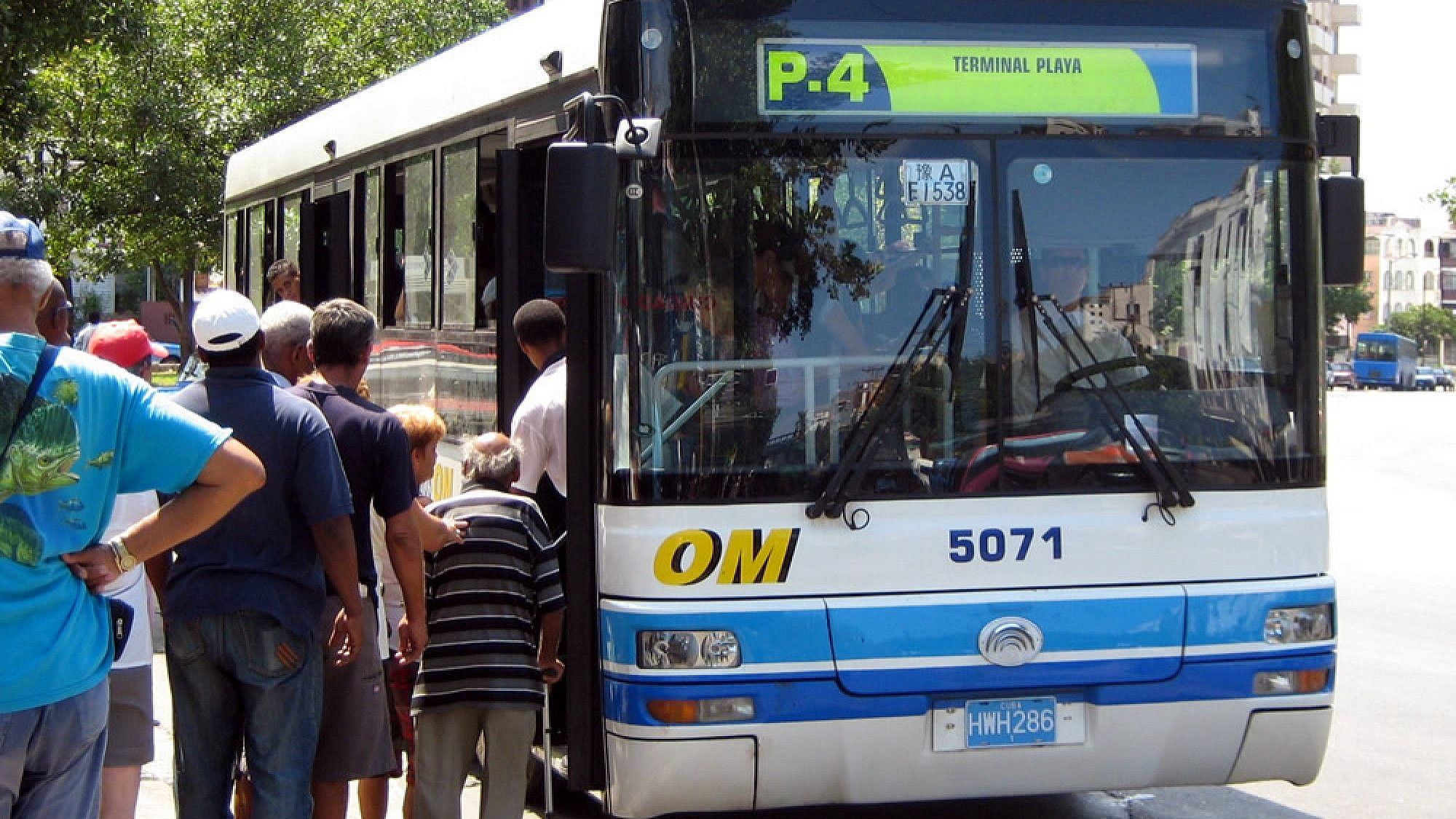 People using a bus in Cuba