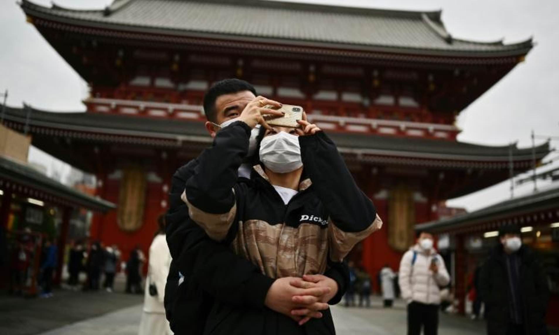 Tokyo residents wearing masks outside shrine