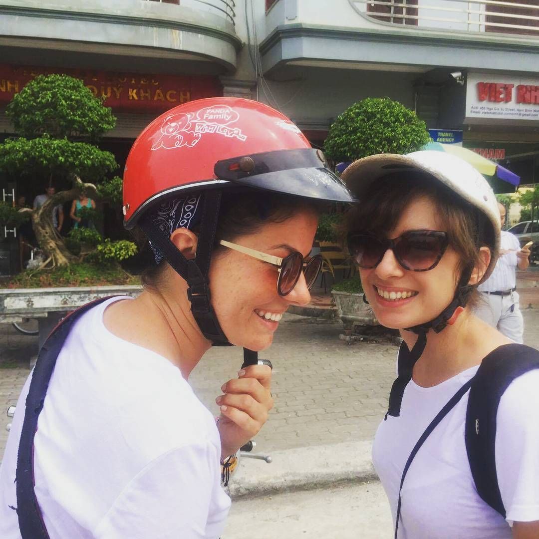 Two women traveling with helmets on