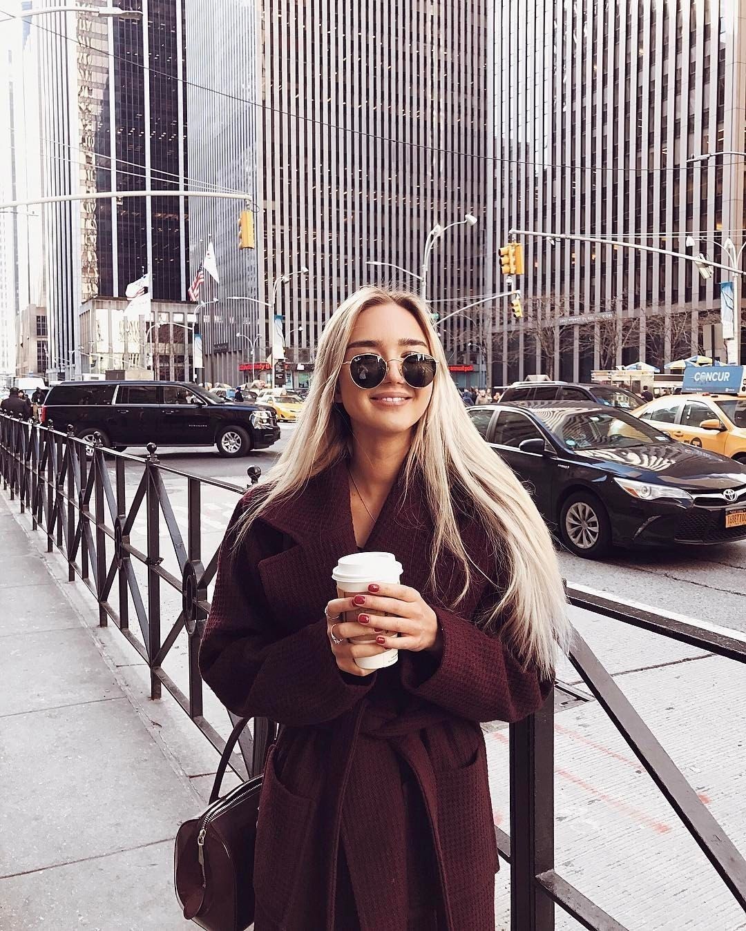 woman in new york city holding coffee cup