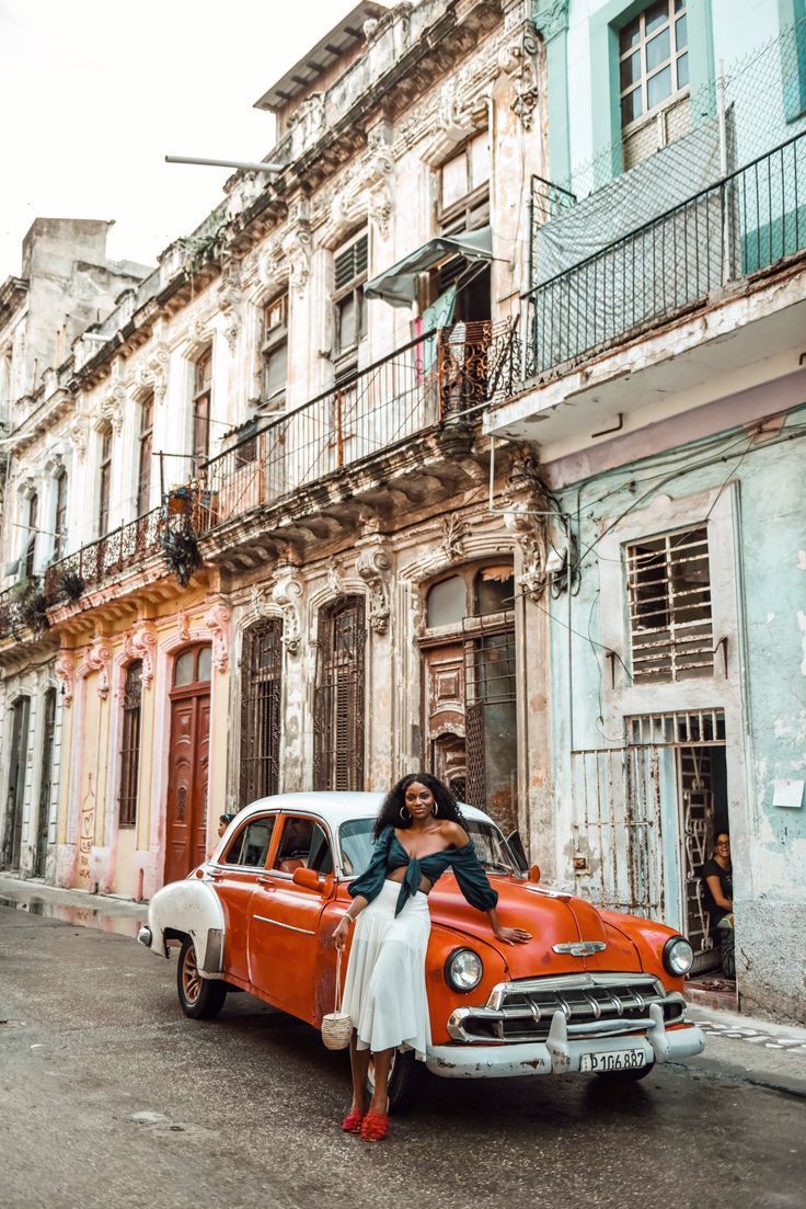 Woman and old car in Cuba