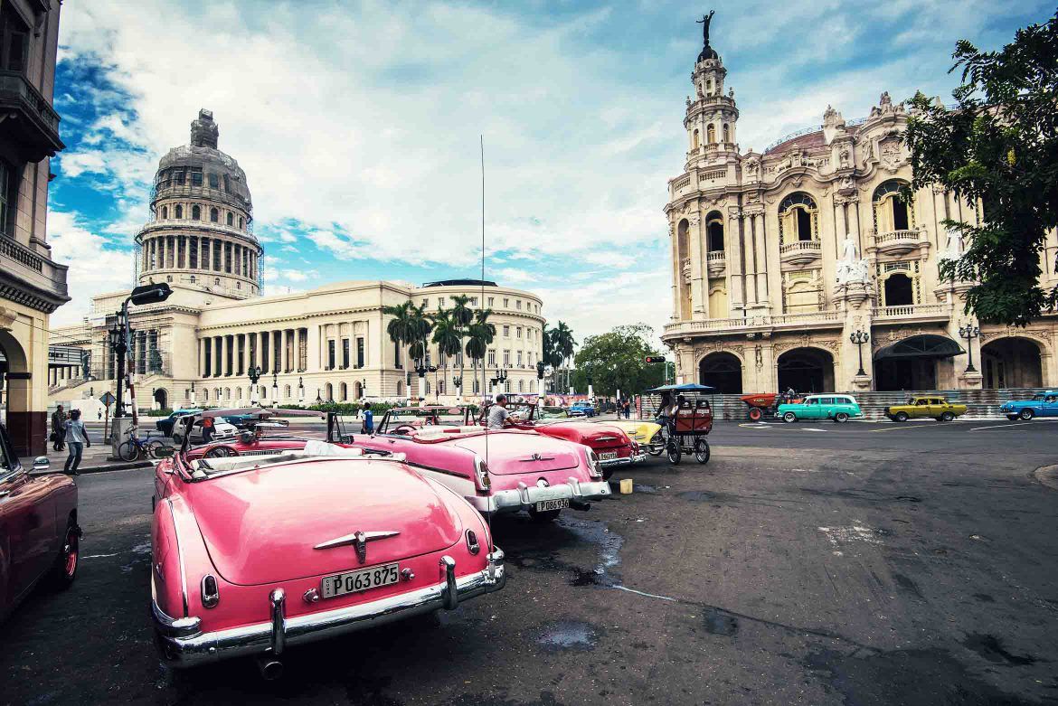 Classic cars parked on a street in Cuba