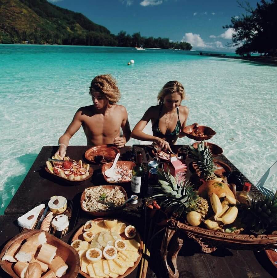 a man and a woman pick fresh food in the middle of the ocean