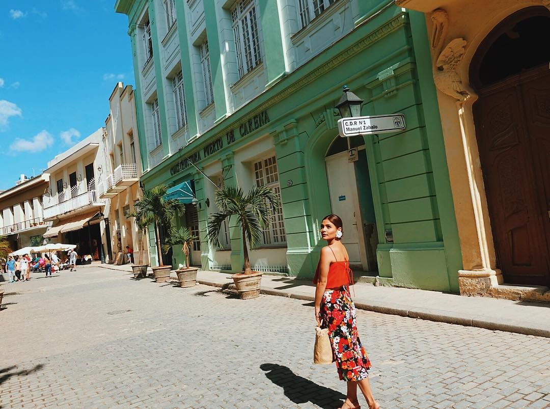 Woman walking along the street in Cuba
