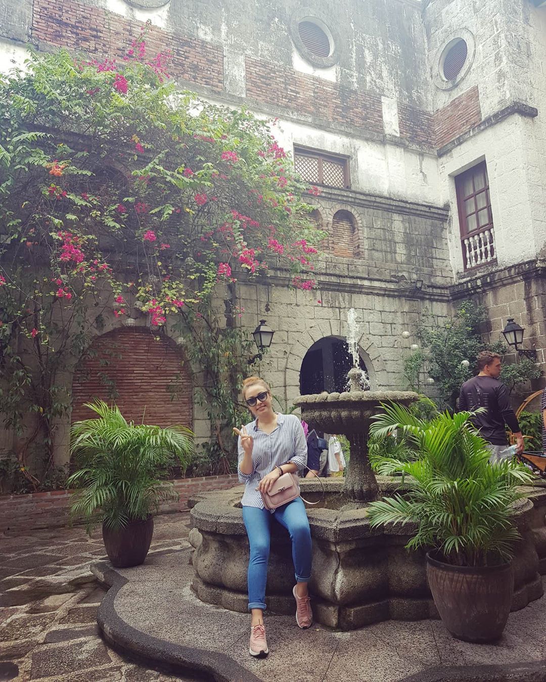 Woman posing in a garden at Casa Manila