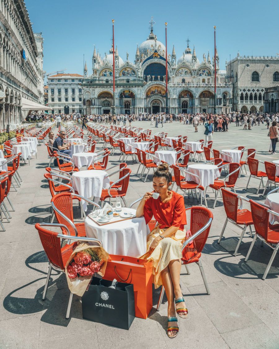 Woman sitting at an outdoor cafe table in Venice