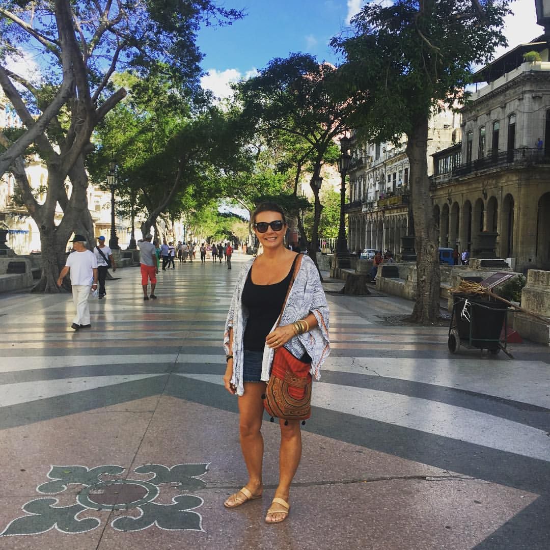 Woman on a sidewalk in Cuba