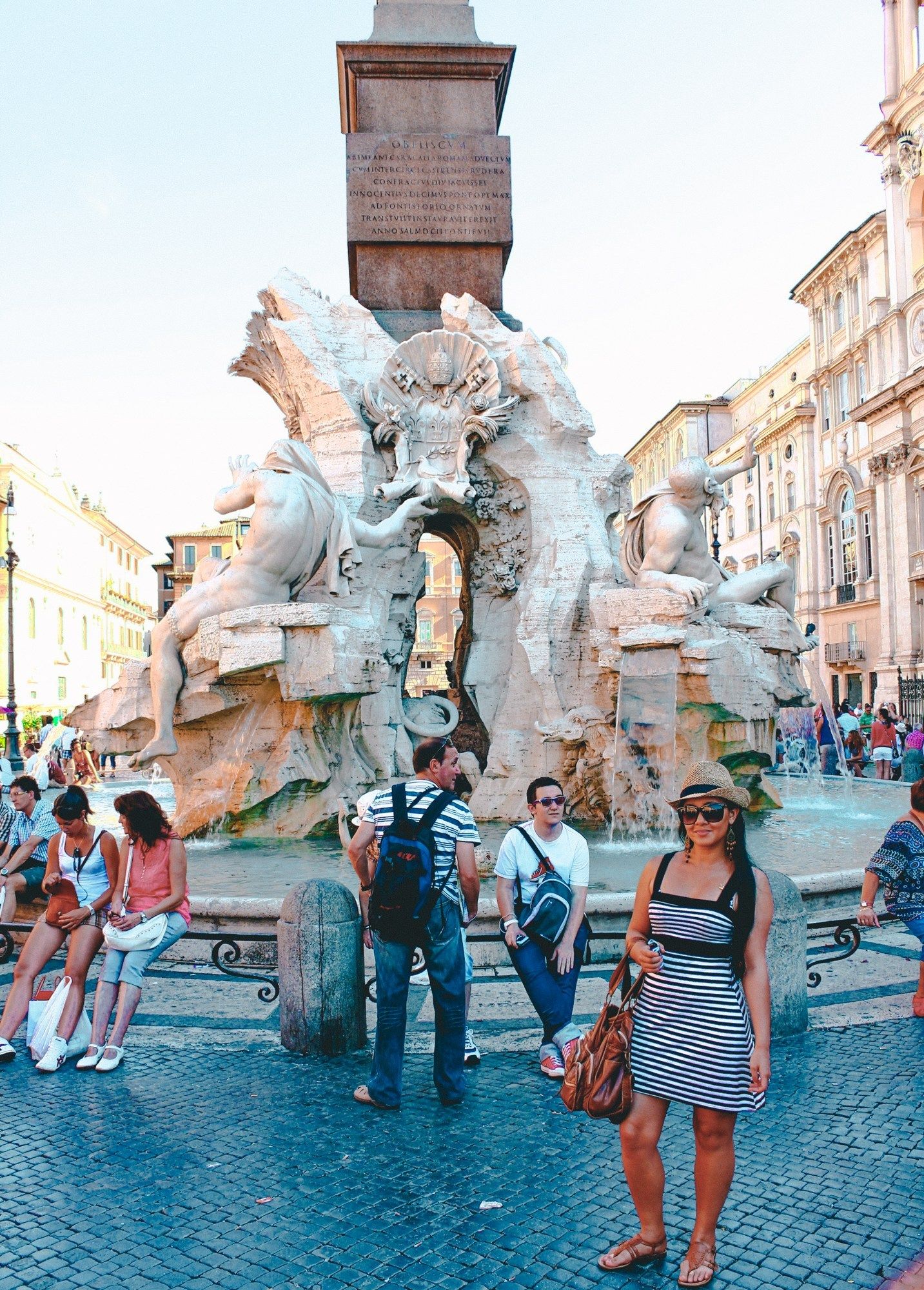 Tourists standing in front of fountain in Italy