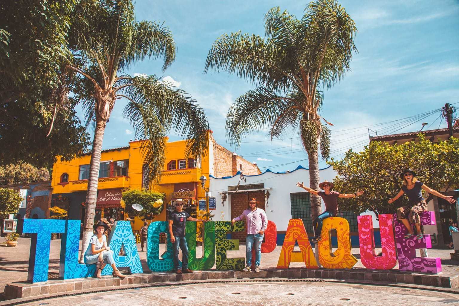 Tourists posing on Tlaquepaque letras in Mexico