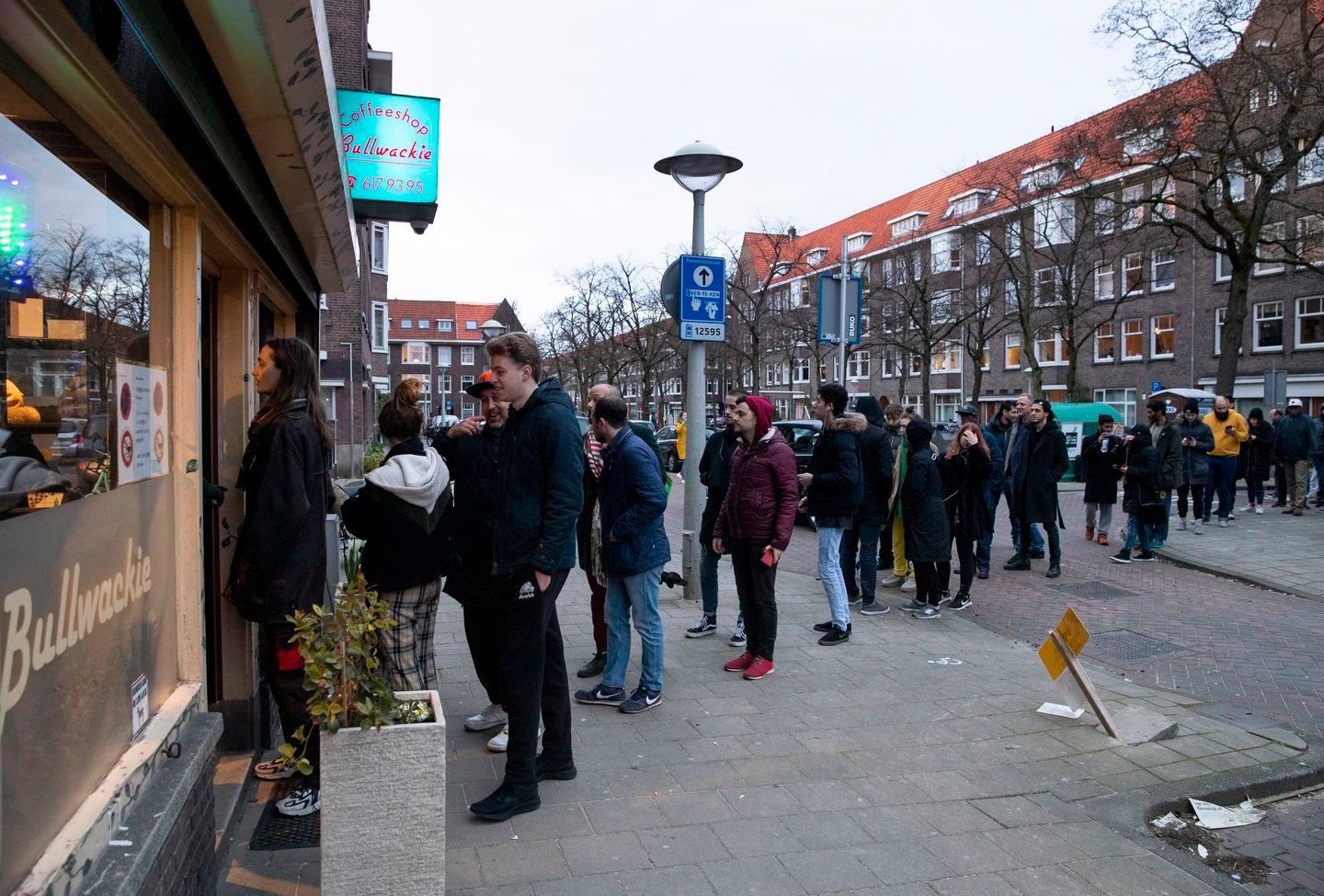 Amsterdam residents line up at Coffeeshops before official closing occurs.