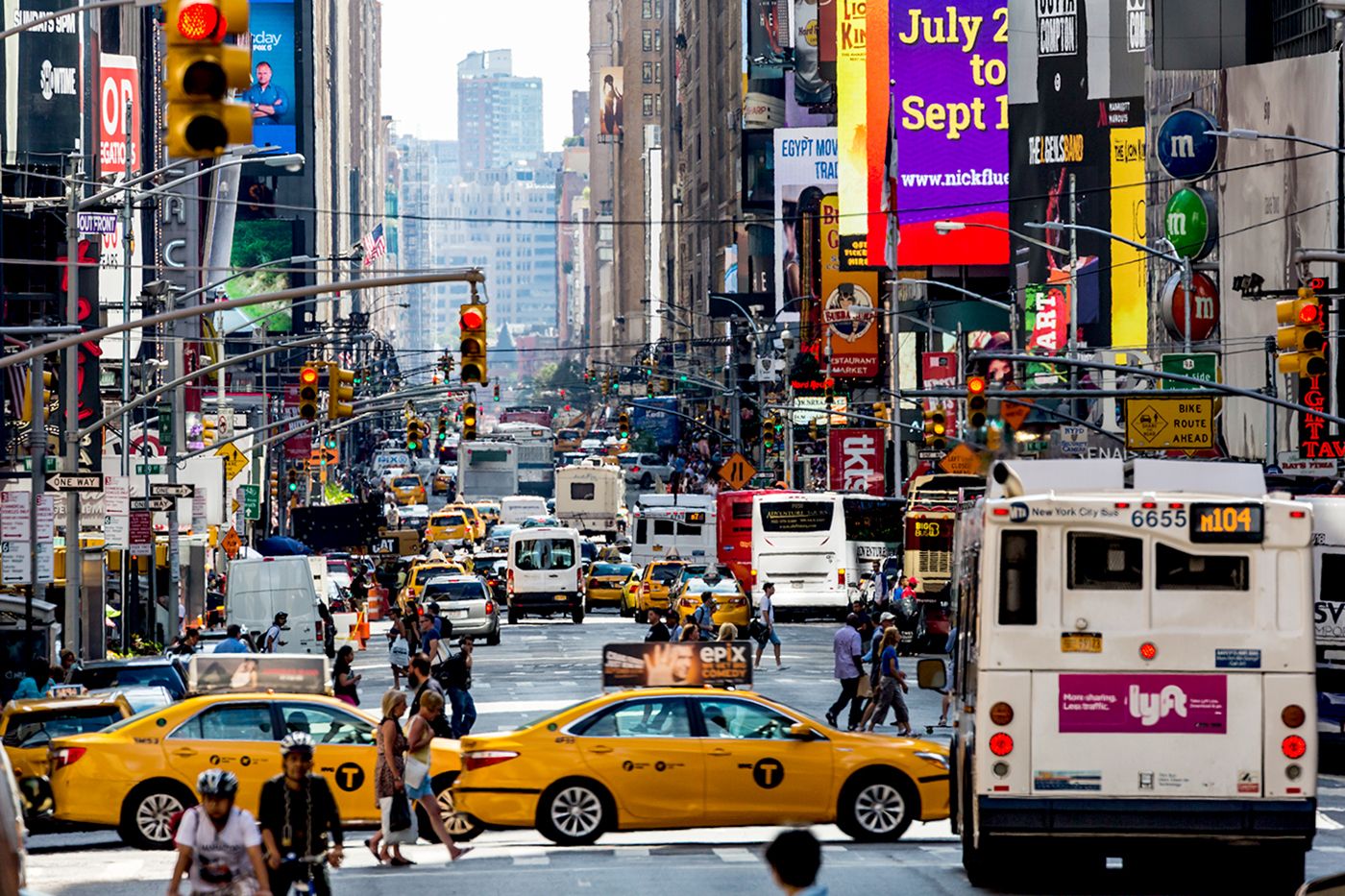 Busy intersection with taxis and people