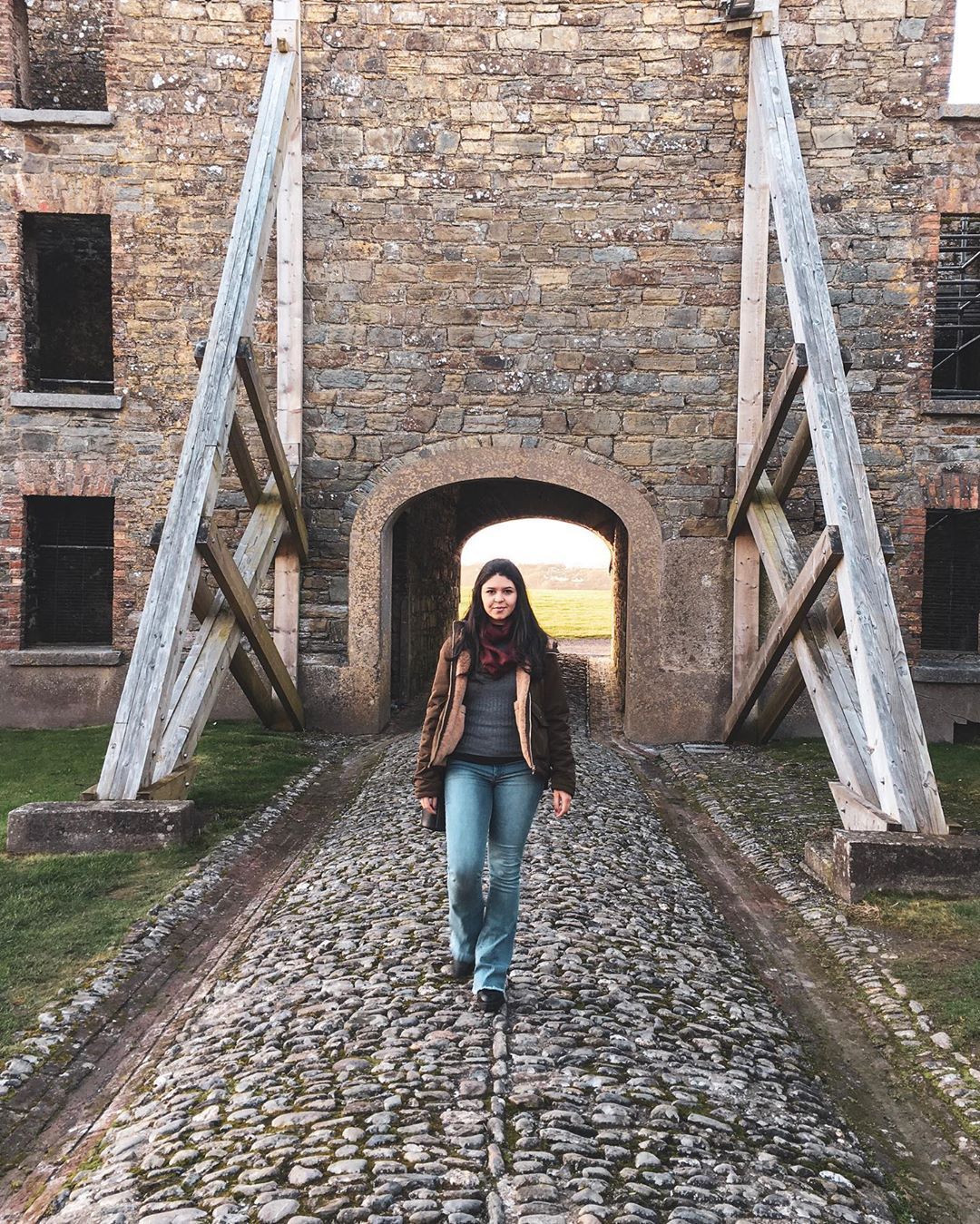 A woman walking away from a castle