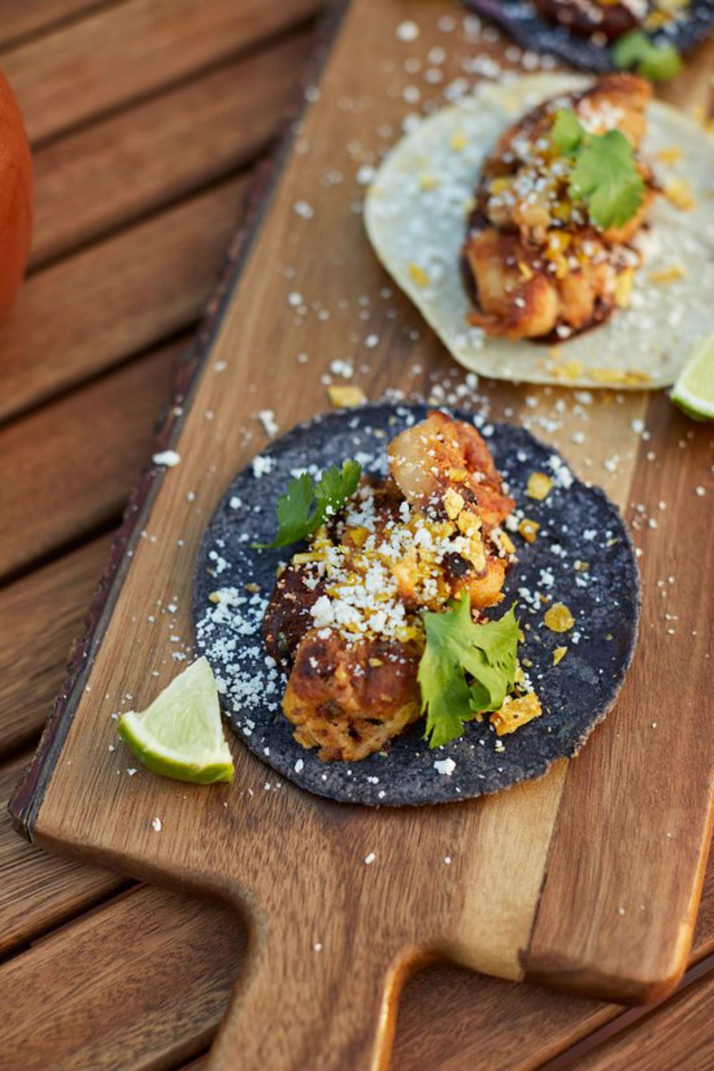 tacos on wooden board on table