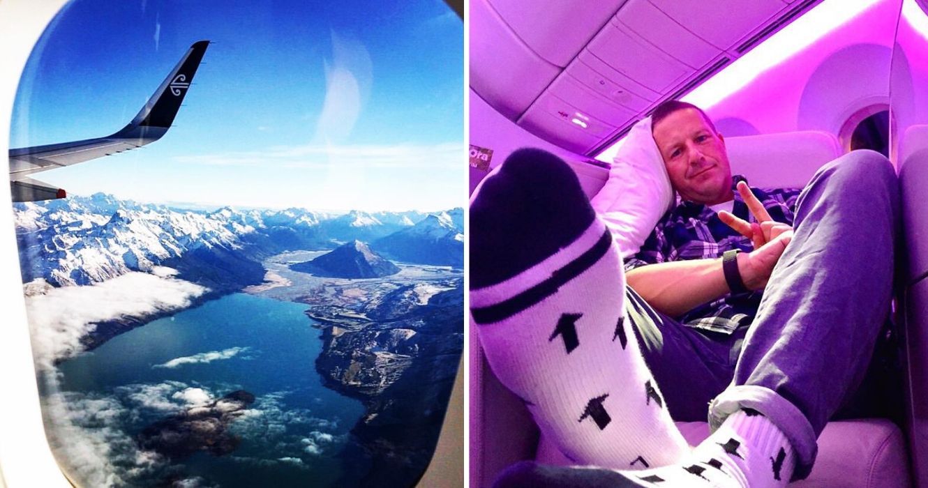 a view out the window of an air new zealand plane, a man takes a selfie on air new zealand in socks