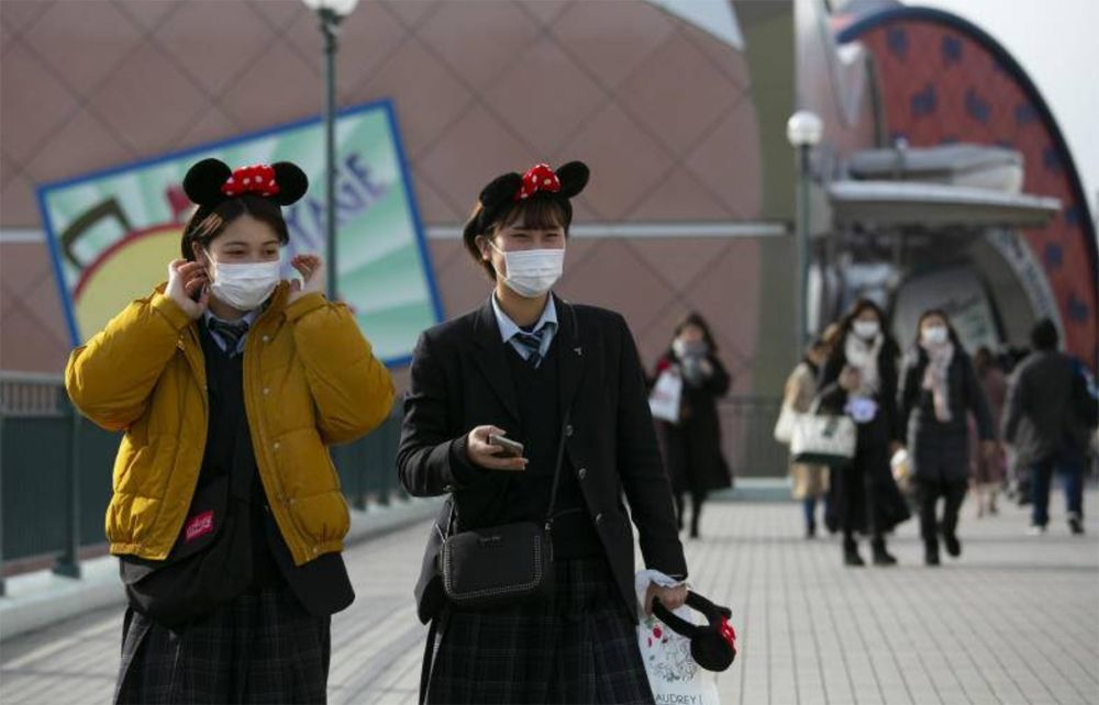 Women in masks at Tokyo Disney