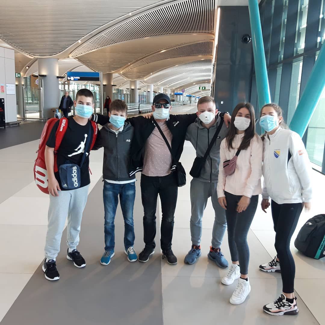 a group of kids in istanbul airport with face masks