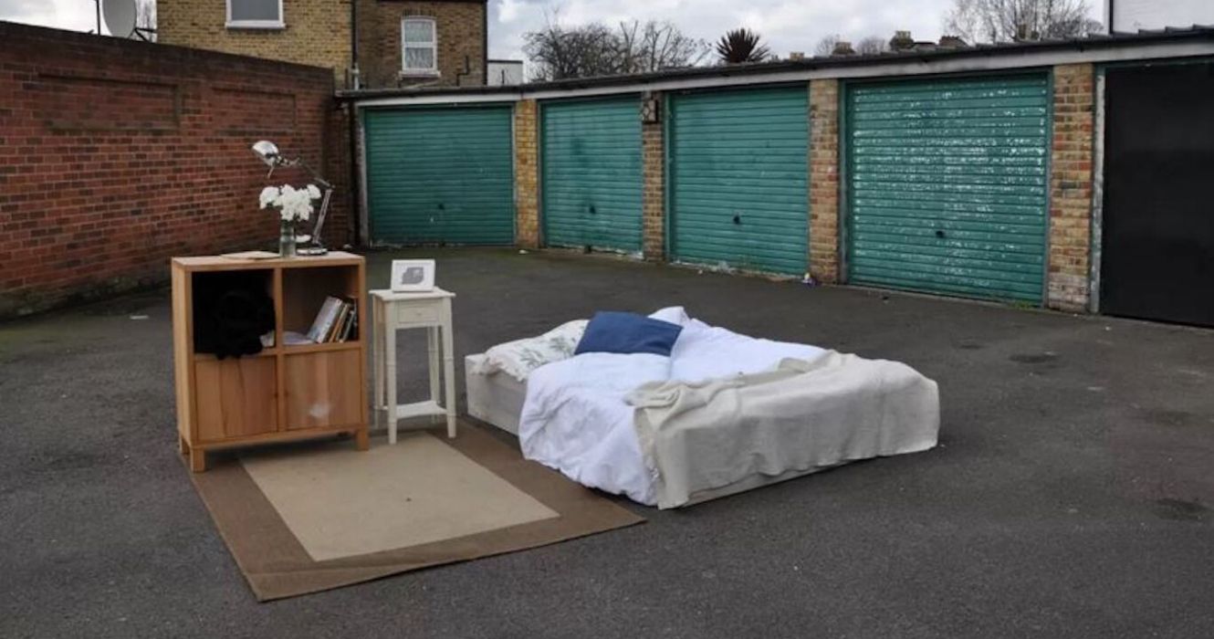 Bed with rug and dresser outdoors at a London AirBnB