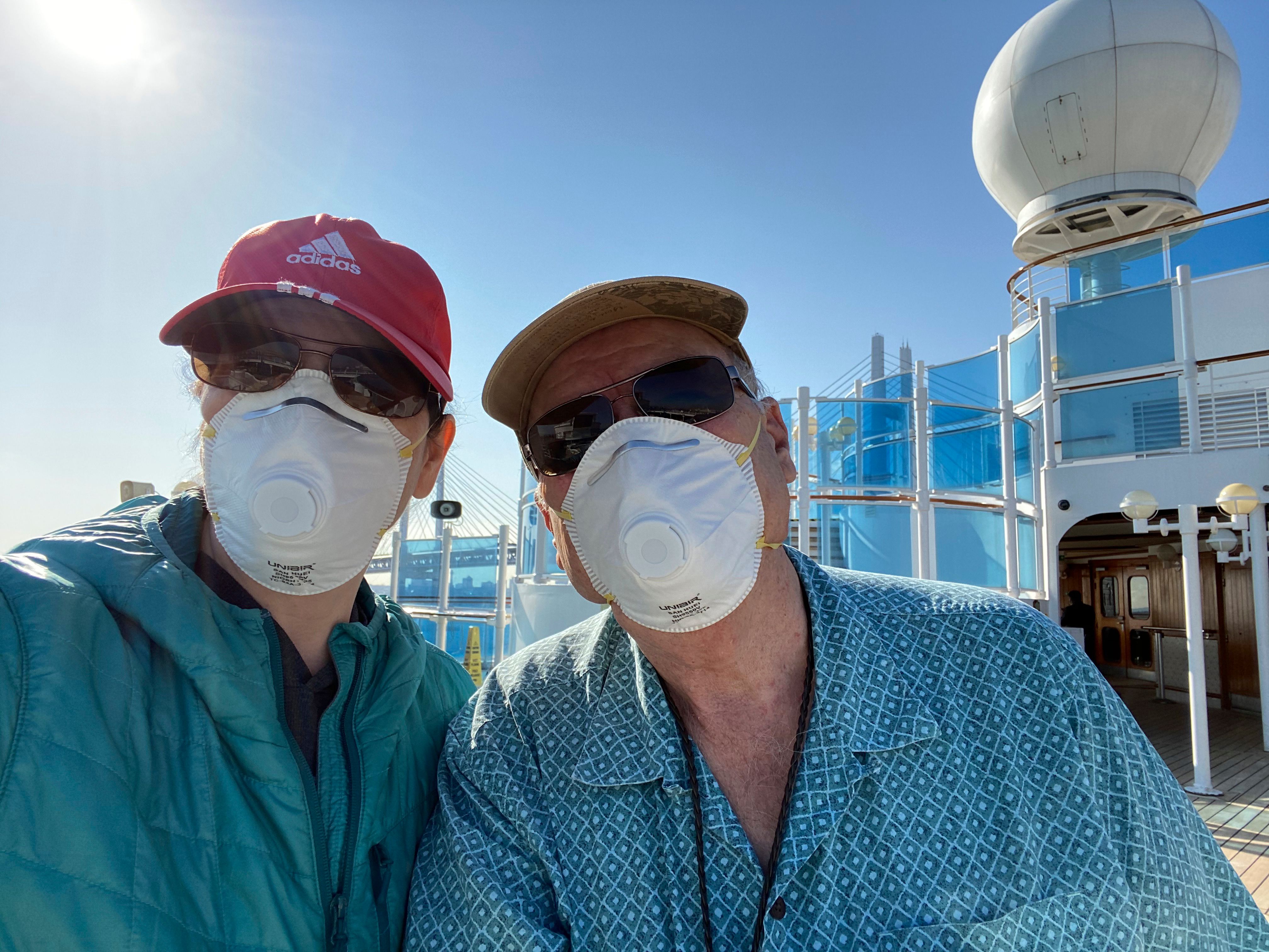 Two passnegers on cruise ship wearing masks