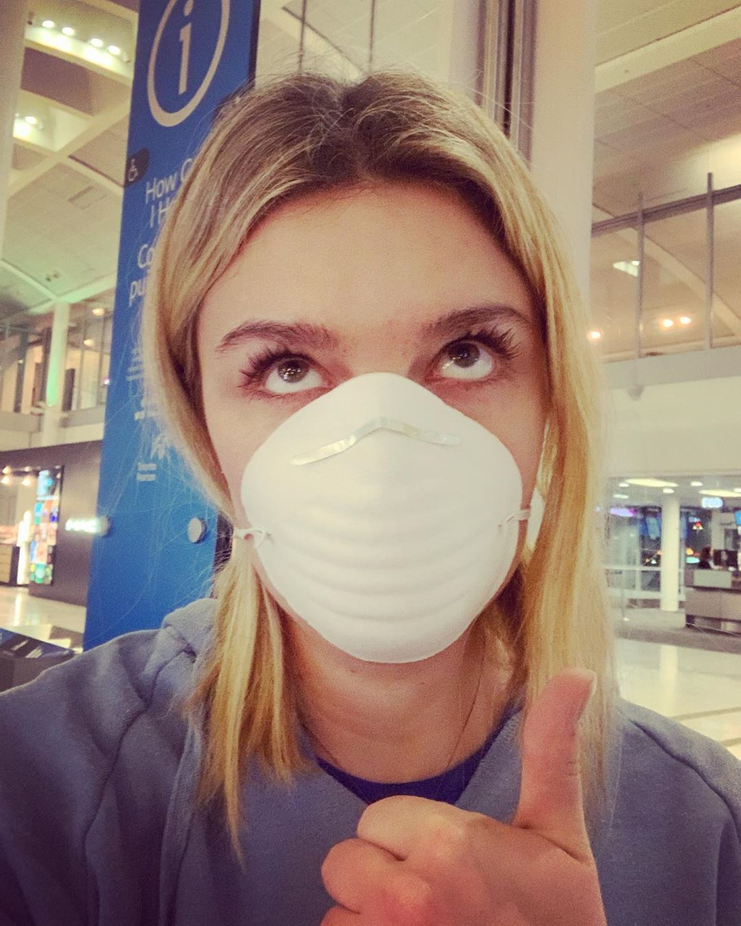 girl with a face mask on an airport