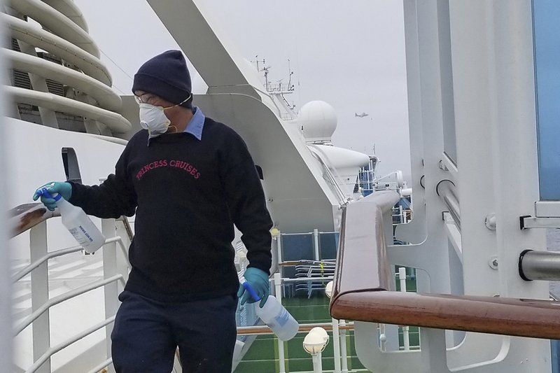 crew member disinfecting ship