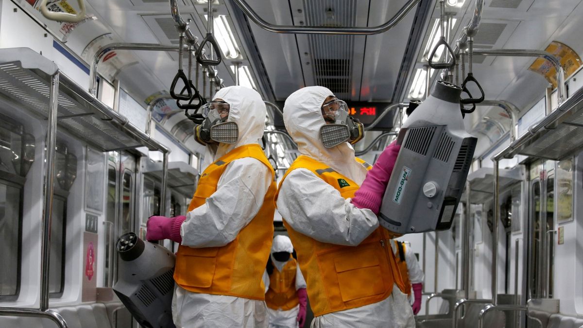 a team in hazmat gear sanitize and disinfect a public transportation subway car