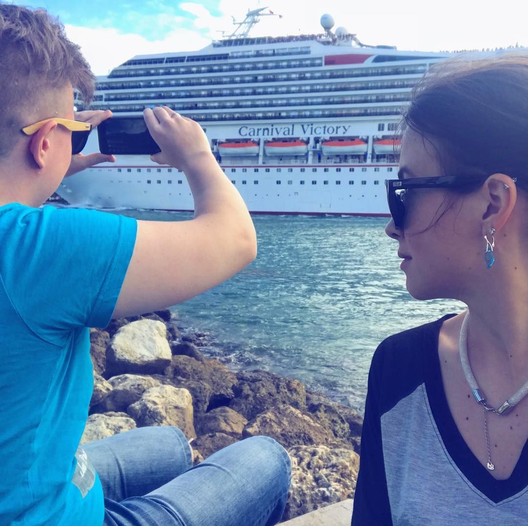 person taking pic of cruise ship