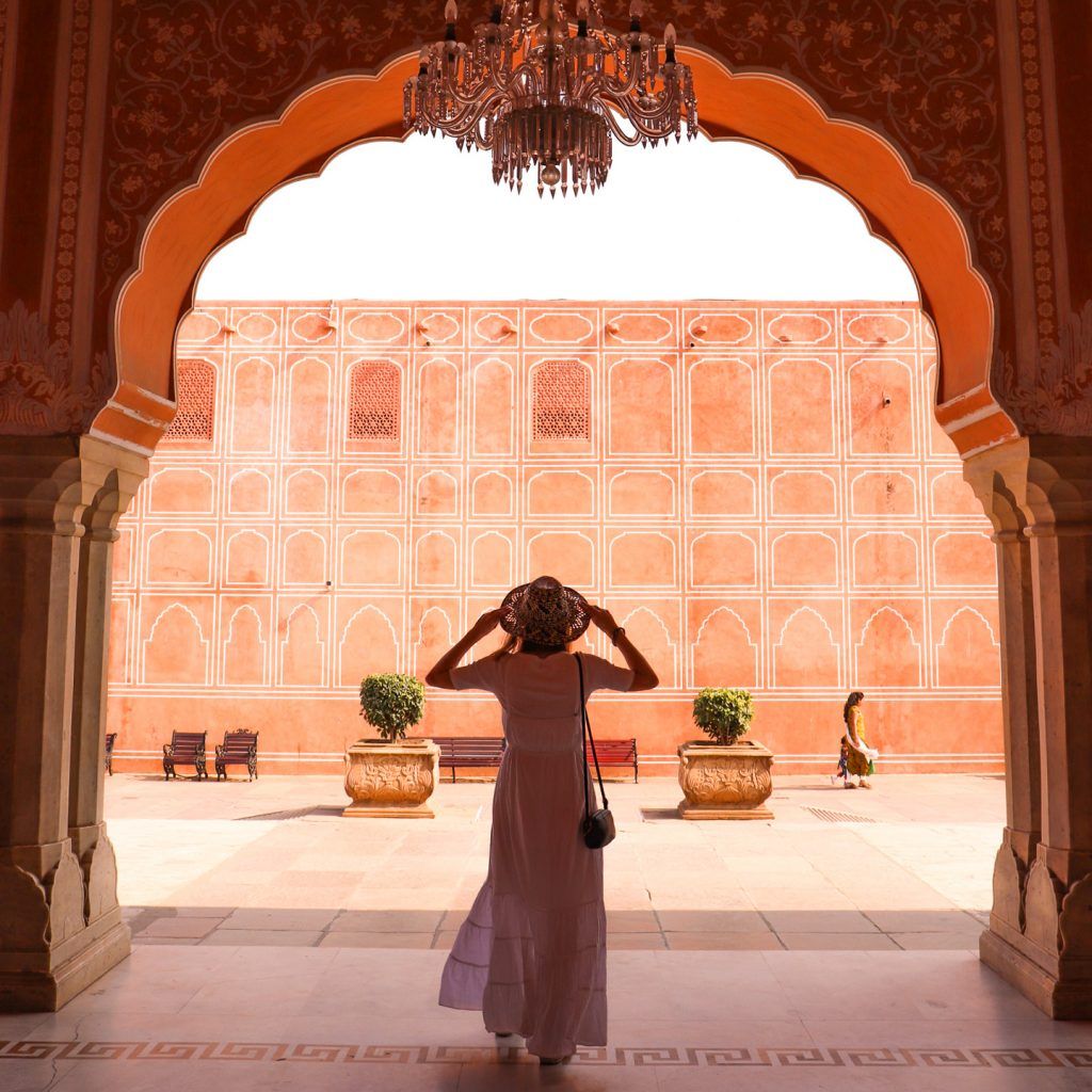 Woman standing in an archway with light filtering around her