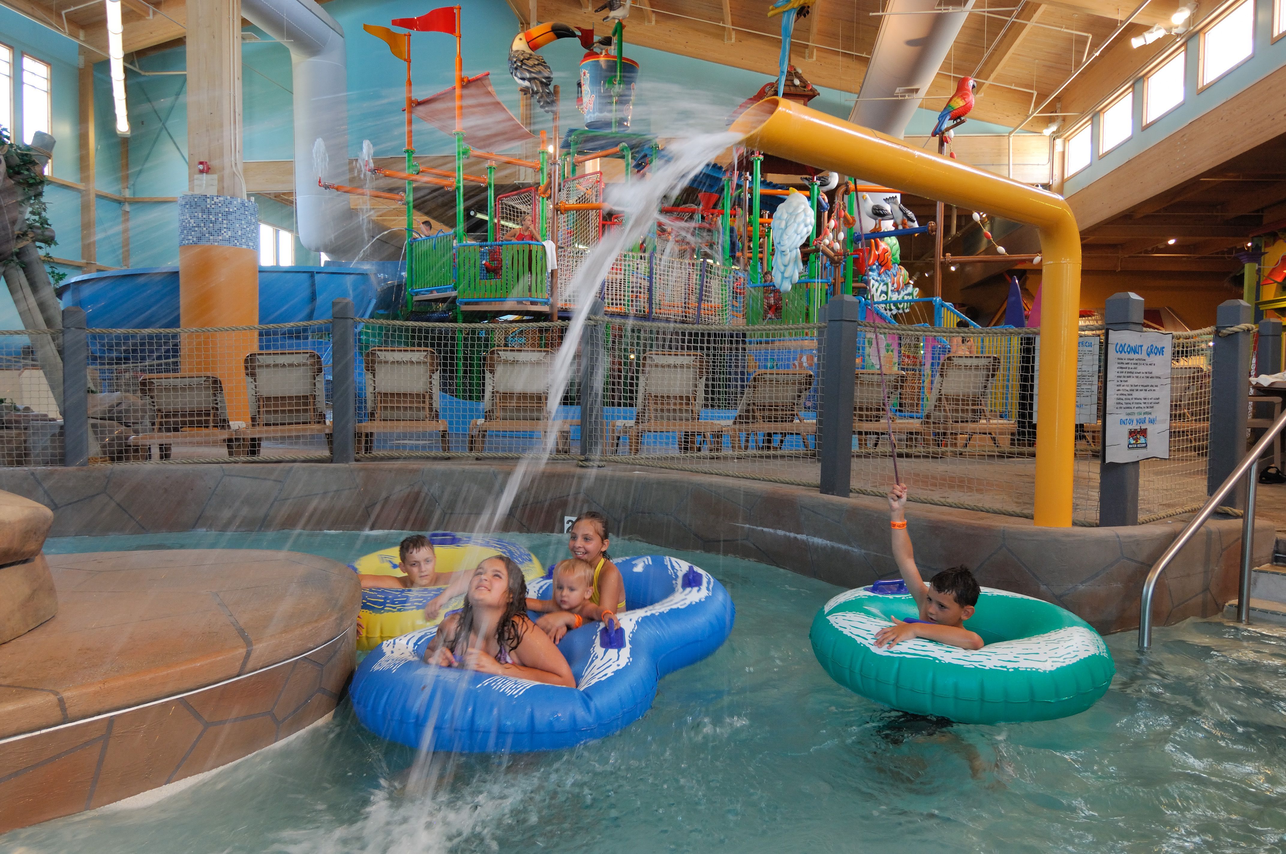 Children floating under a stream of water in a water park