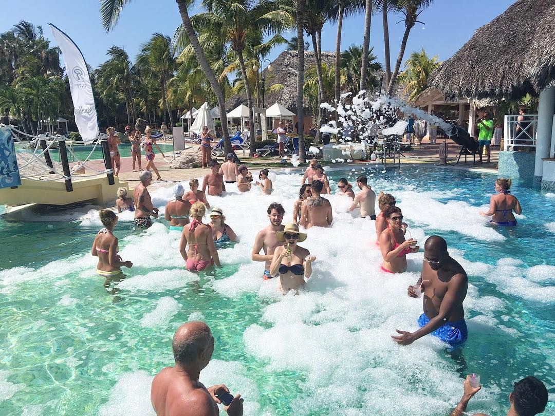 People having fun in a pool at a resort