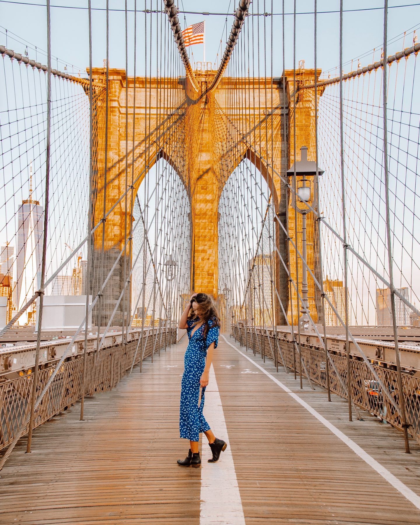 Girl standing in the middle of the Brooklyn Bridge